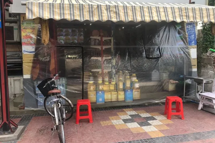 The Ah Yee Taung shop seen from the street, with red stools out front.